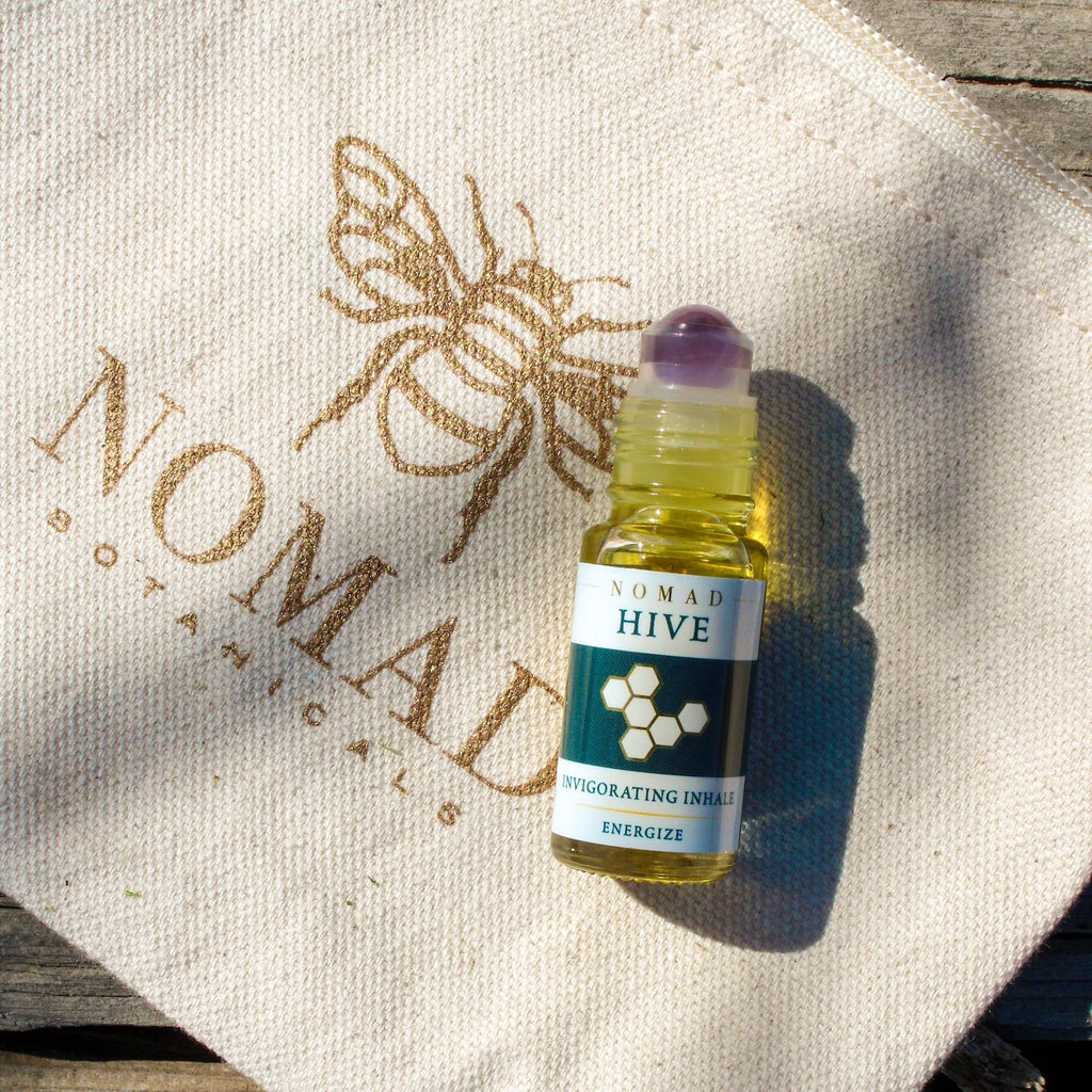 Energizing aromatherapy blend 5 ml bottle topped with an amethyst roller ball on travel cotton bag