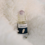 Vitality Elixir Aromatherapy Essential Oil Blend nestled in a cocoon-like blanket