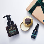 Holiday Gift Box collection of Nomad Botanicals Forest Sanctuary Foaming Hand Wash, Moisturizing Hand Purifier, and Candle